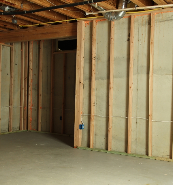 Build a Grid to Hold the Insulation Wood wall frame grid without insulation | How To Insulate Your Basement | The Basement Doctor