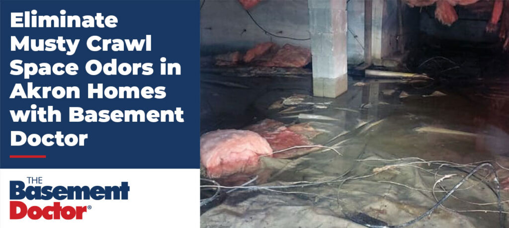 Flooded and musty crawl space in an Akron home with standing water and fallen insulation, highlighting moisture and odor problems.