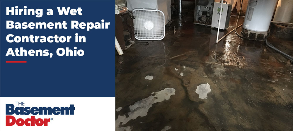Wet basement in Athens Ohio with standing water on concrete floor and visible moisture damage near home appliances.